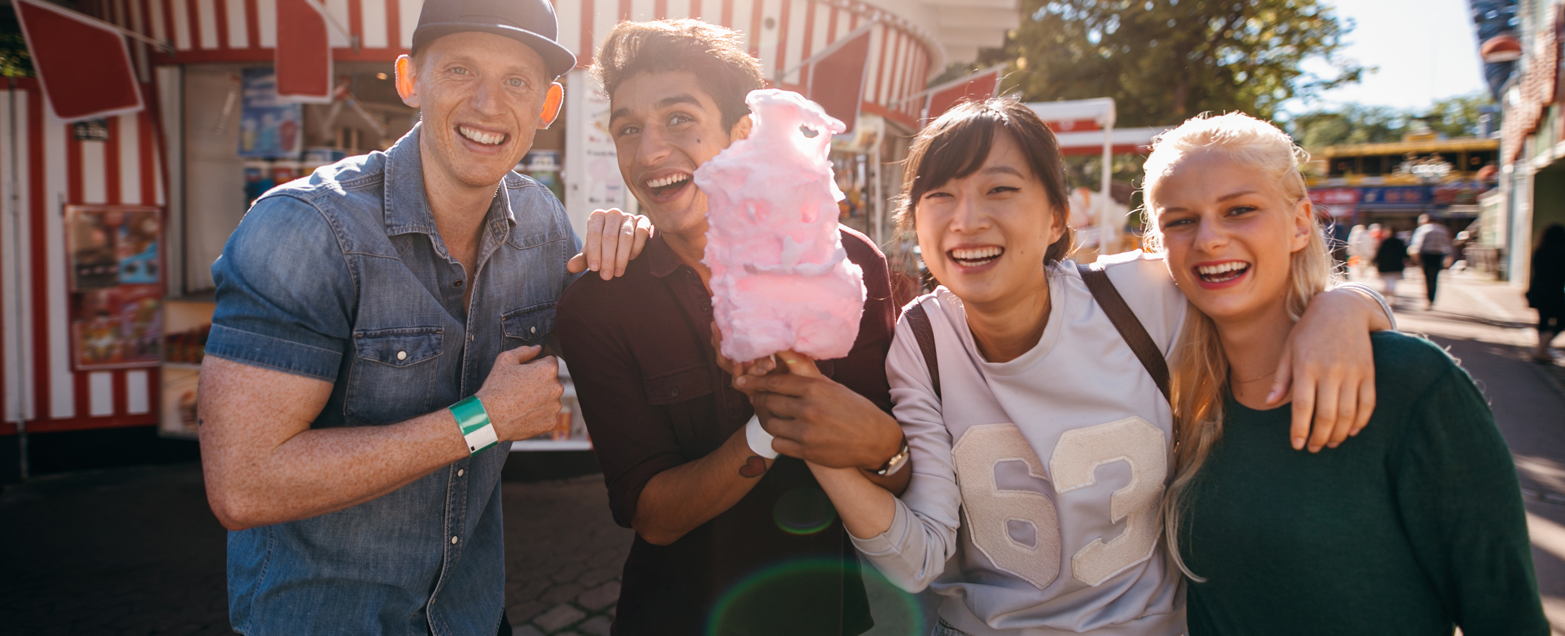 Happy group of people enjoying cotton candy
