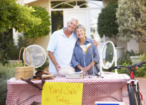 Cute older couple having a yard sale